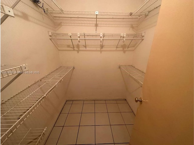 spacious closet featuring tile patterned floors