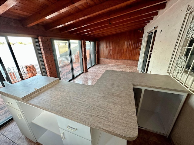 sunroom with wooden ceiling and beamed ceiling