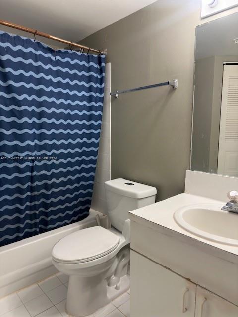 bathroom featuring tile patterned floors, vanity, and toilet