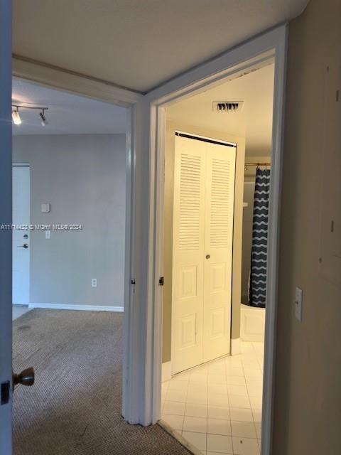 corridor with light tile patterned floors