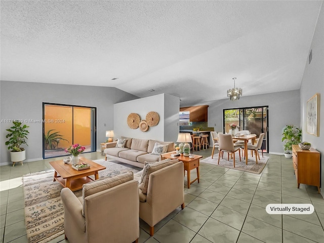 living room featuring a notable chandelier, light tile patterned floors, and vaulted ceiling