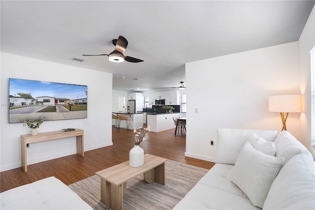 living room featuring ceiling fan and light wood-type flooring