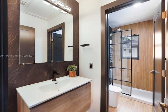 bathroom with tasteful backsplash, a shower, wood-type flooring, toilet, and vanity