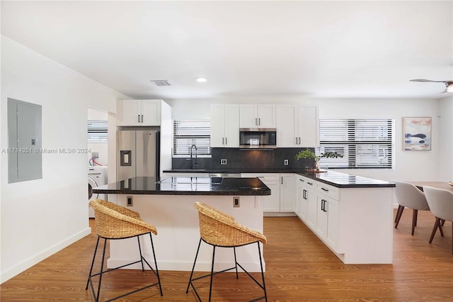 kitchen featuring white cabinets, appliances with stainless steel finishes, and a kitchen island