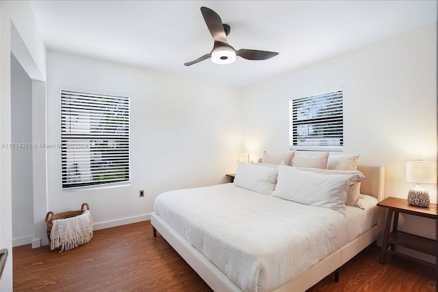 bedroom with ceiling fan and dark hardwood / wood-style flooring