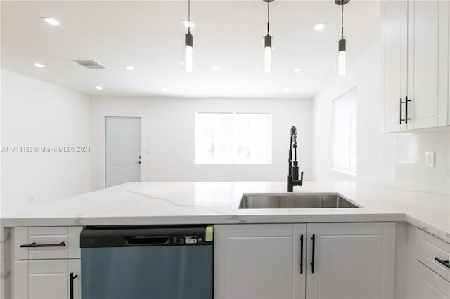 kitchen with pendant lighting, dishwasher, white cabinetry, and sink