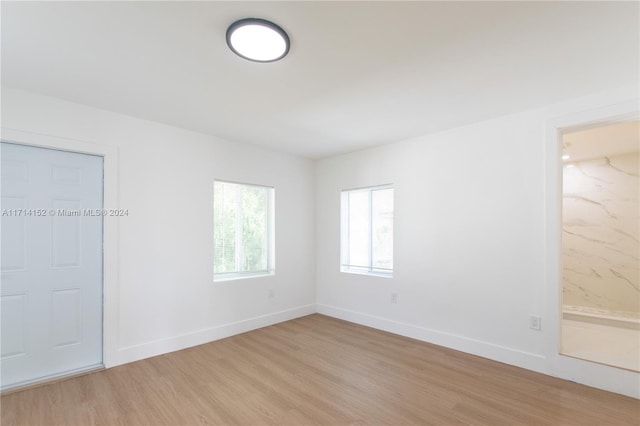 empty room with light hardwood / wood-style flooring