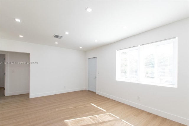 spare room with light hardwood / wood-style flooring