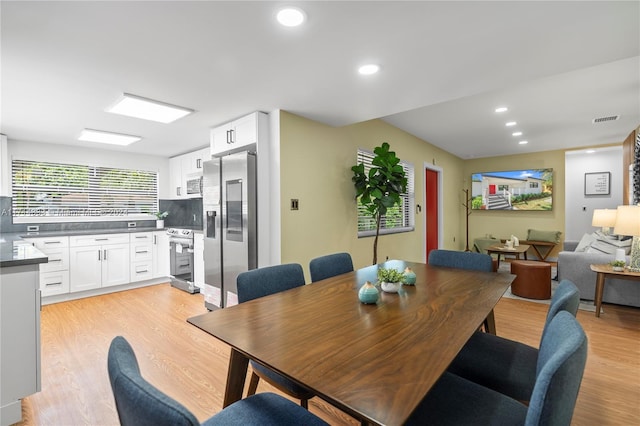 dining space with light hardwood / wood-style flooring