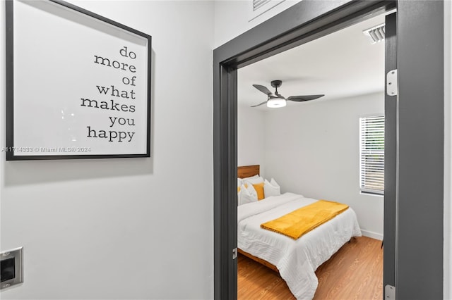 bedroom with ceiling fan and wood-type flooring