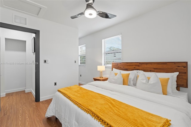 bedroom with ceiling fan and hardwood / wood-style floors