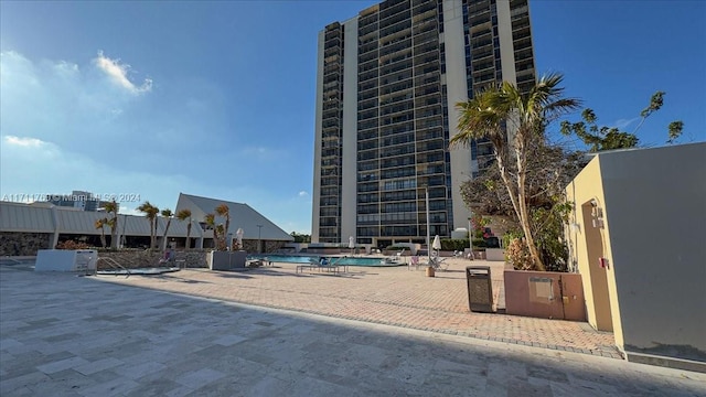 view of building exterior featuring a community pool