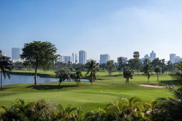 view of property's community with a lawn and a water view