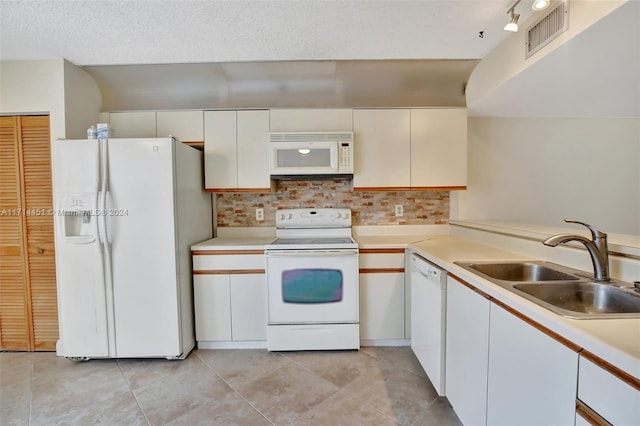 kitchen featuring backsplash, white appliances, a textured ceiling, white cabinets, and sink