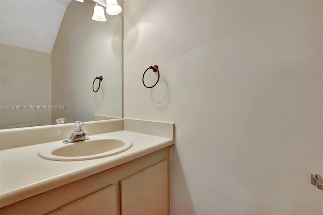 bathroom with vanity and vaulted ceiling