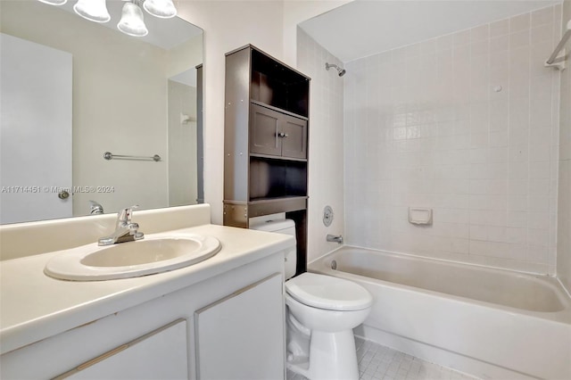 full bathroom featuring toilet, tile patterned flooring, tiled shower / bath, and vanity