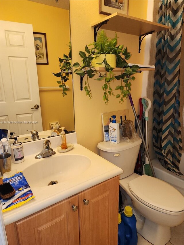 bathroom featuring tile patterned flooring, vanity, and toilet