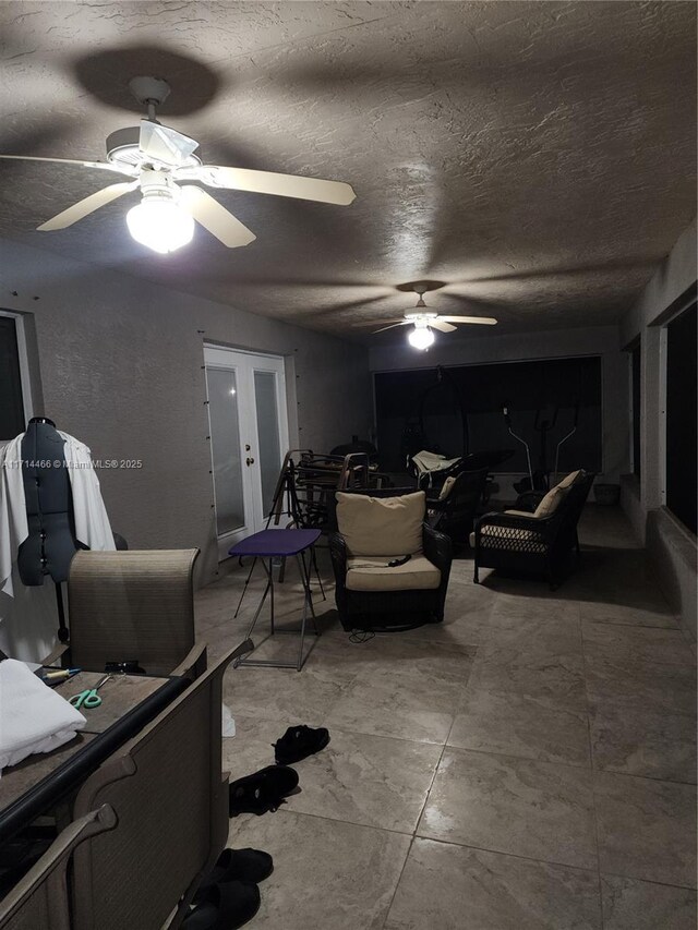 living room featuring french doors, a textured ceiling, and ceiling fan