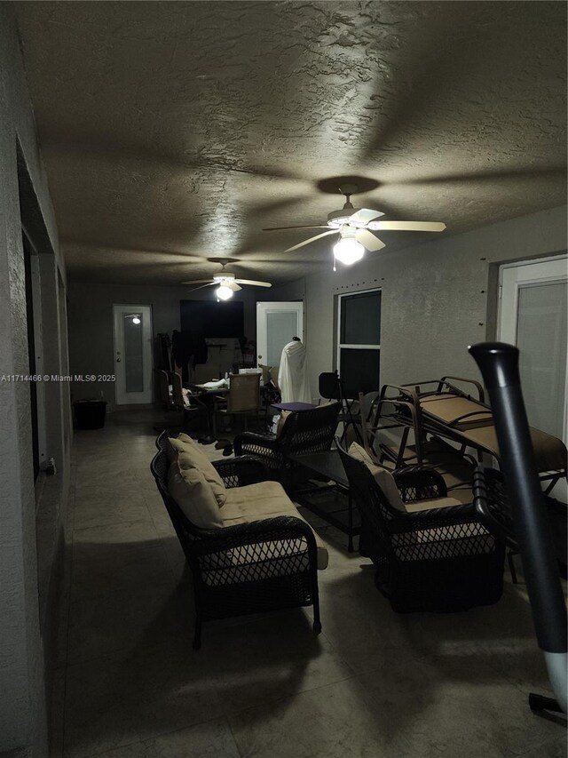 interior space featuring ceiling fan and a textured ceiling