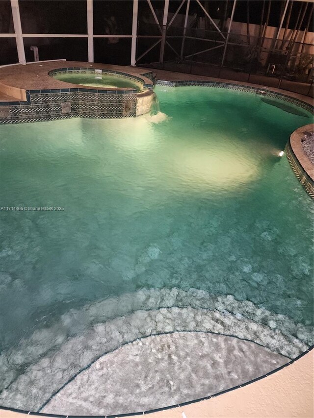 view of pool with an in ground hot tub