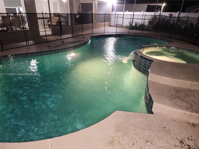 view of swimming pool featuring a lanai and an in ground hot tub