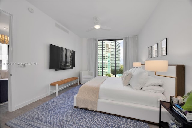 bedroom featuring access to outside, dark hardwood / wood-style floors, and ceiling fan