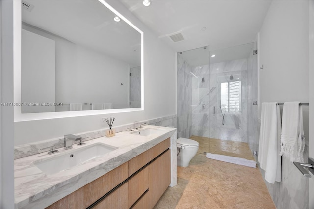 bathroom featuring tile patterned floors, vanity, a shower with door, tile walls, and toilet