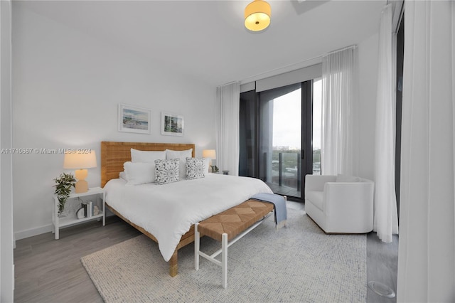 bedroom featuring hardwood / wood-style floors and access to outside