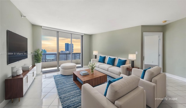 living area featuring expansive windows, light tile patterned floors, baseboards, and a city view