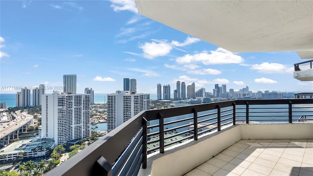 balcony featuring a water view and a view of city