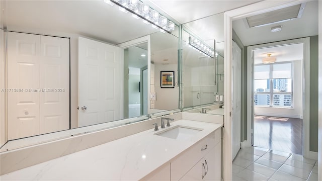 bathroom featuring baseboards, tile patterned flooring, and vanity