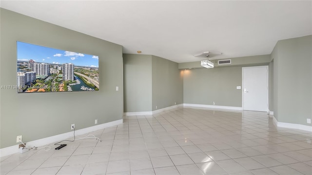 spare room featuring visible vents, baseboards, and light tile patterned flooring