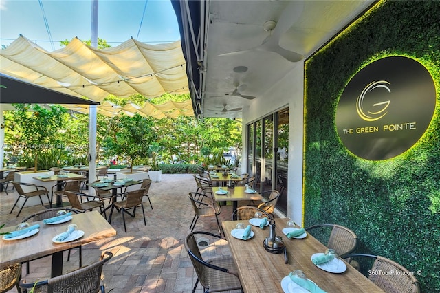 view of patio with outdoor dining space, a pergola, and a ceiling fan