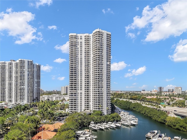 view of building exterior with a water view and a city view