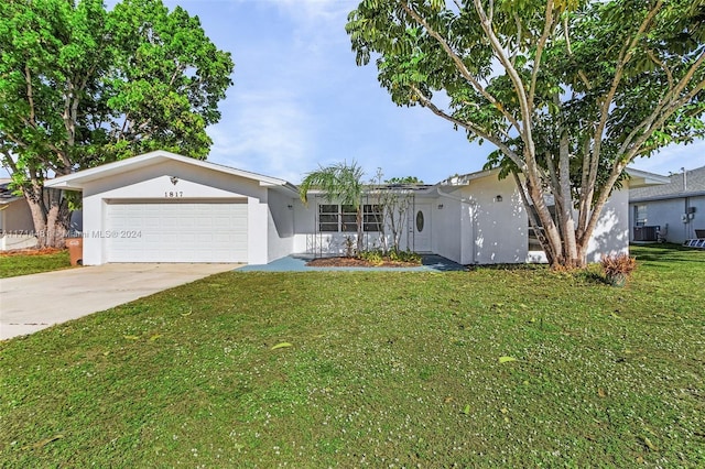 single story home featuring a front yard and a garage