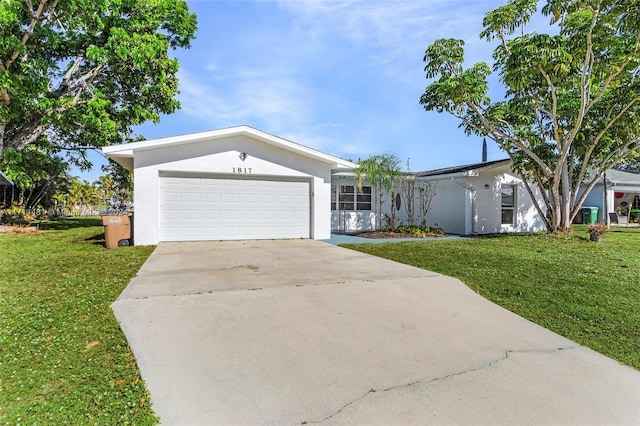 ranch-style home featuring a front lawn and a garage