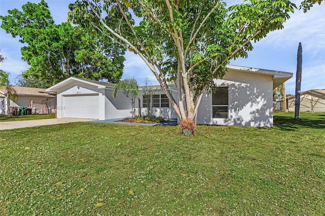 ranch-style home featuring a garage and a front lawn