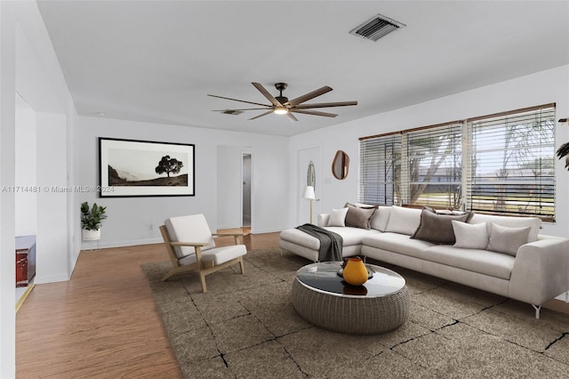 living room with wood-type flooring and ceiling fan