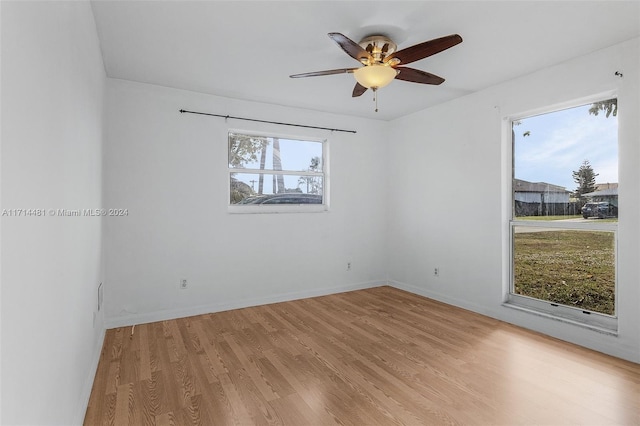 empty room with ceiling fan and light hardwood / wood-style floors