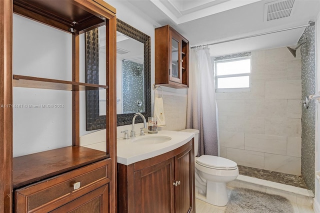 bathroom featuring a shower with shower curtain, vanity, toilet, and tile patterned floors