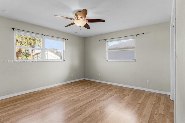 spare room with light hardwood / wood-style floors and ceiling fan