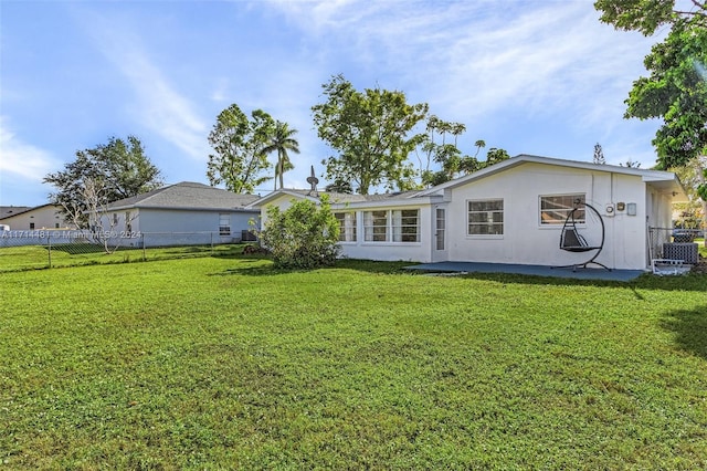 rear view of property featuring a yard