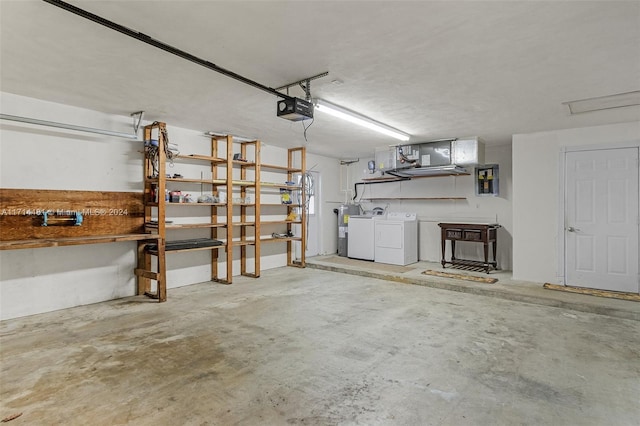 garage featuring independent washer and dryer, electric water heater, and a garage door opener