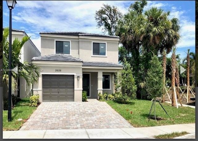 front of property featuring a front yard and a garage