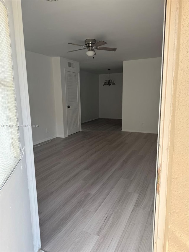 unfurnished room with ceiling fan and wood-type flooring