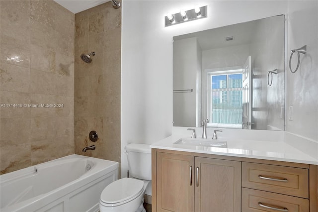 full bathroom featuring vanity, tiled shower / bath combo, and toilet