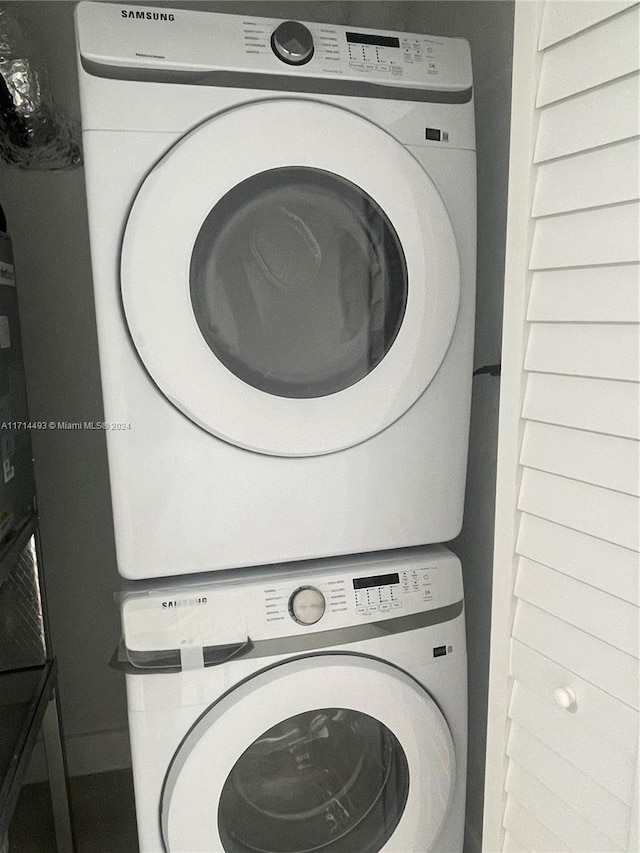 clothes washing area with stacked washer and clothes dryer