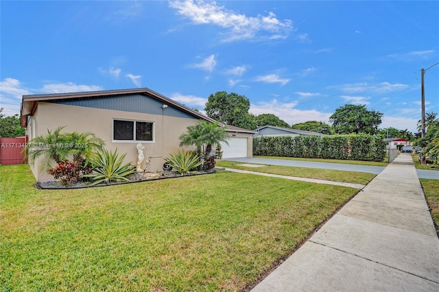 view of front of home with a garage and a front lawn