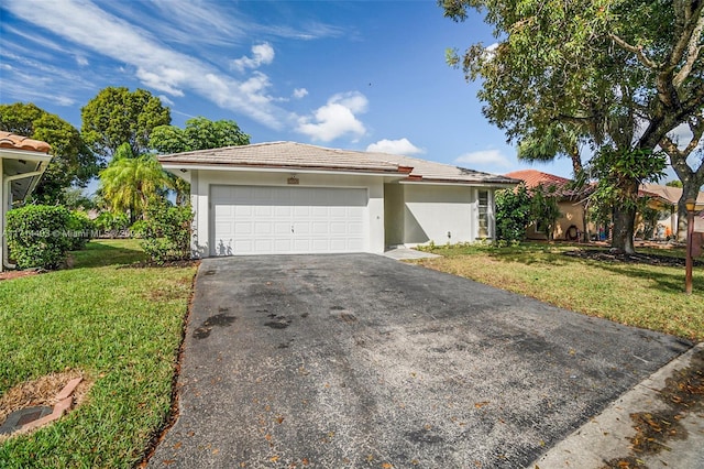 single story home with a garage and a front lawn