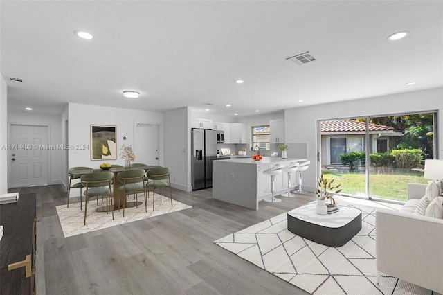 living room with plenty of natural light and light hardwood / wood-style floors